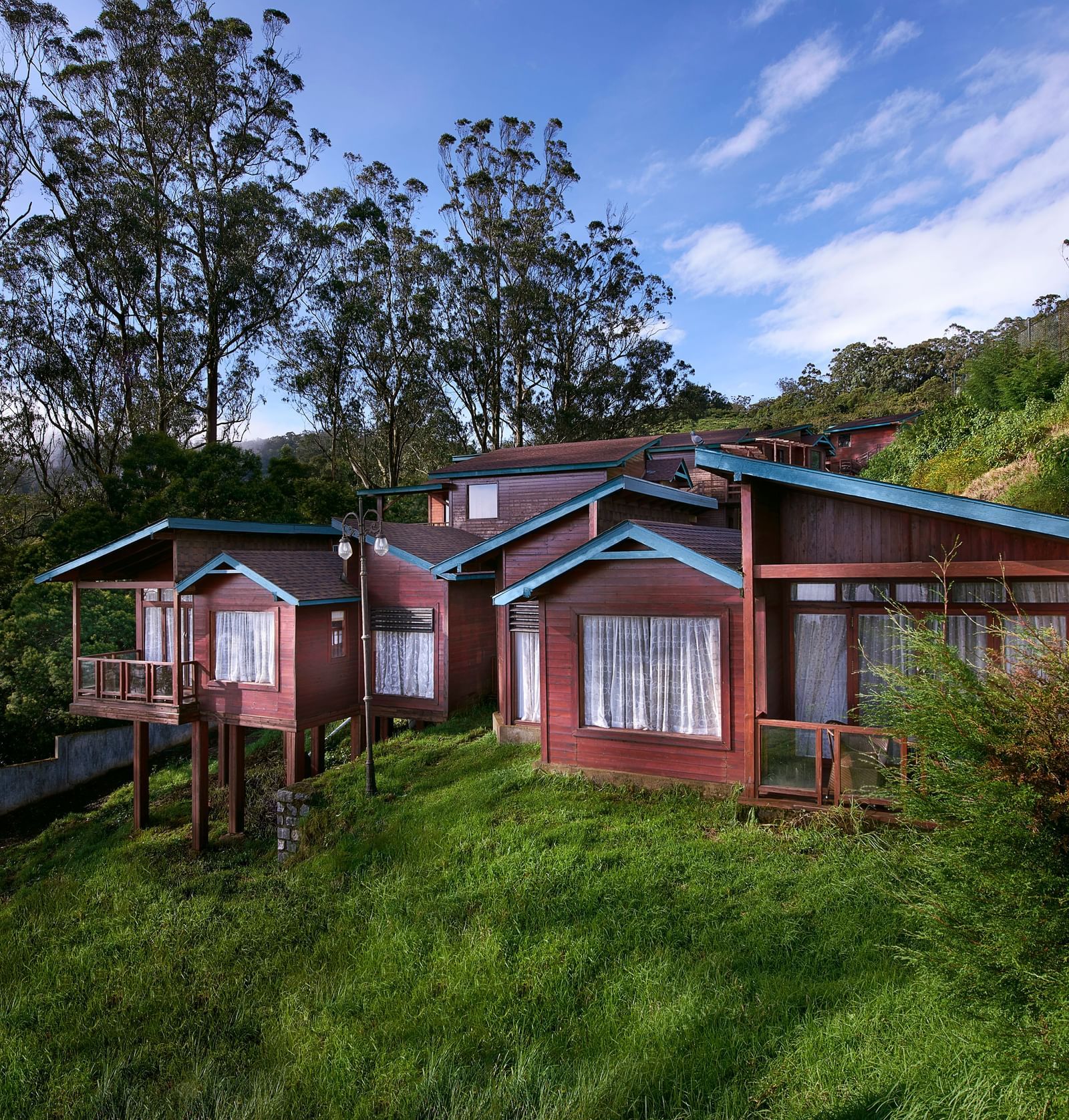 An image of a villa set amidst the hills filled with plants and trees - Accord Hotels and Resorts